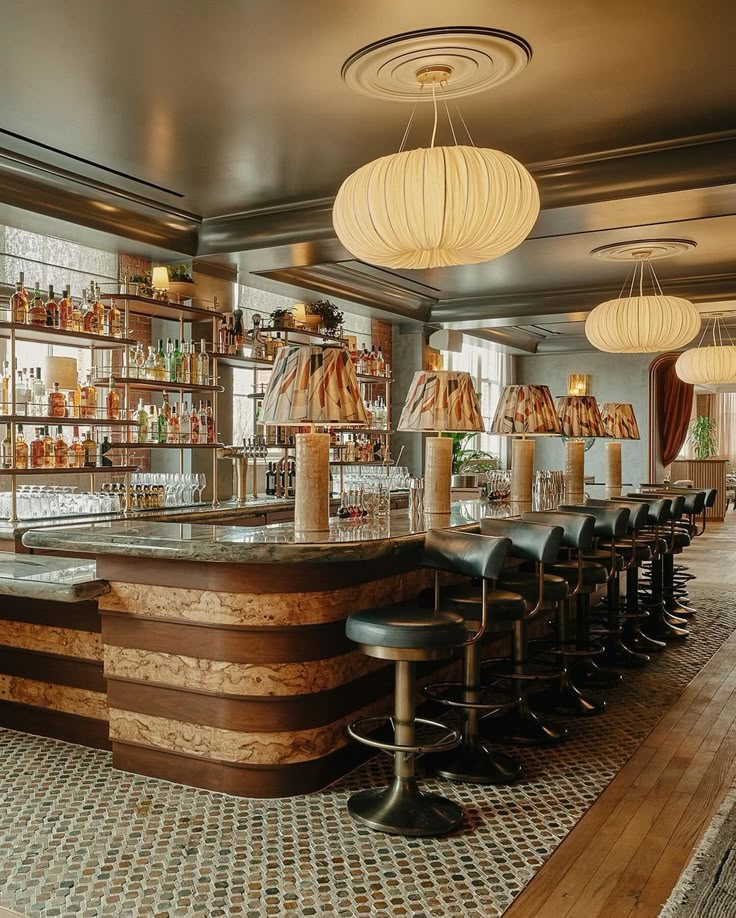 a bar with lots of stools and lights