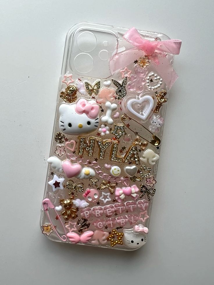 an iphone case with hello kitty and other items on it, all covered in glitter