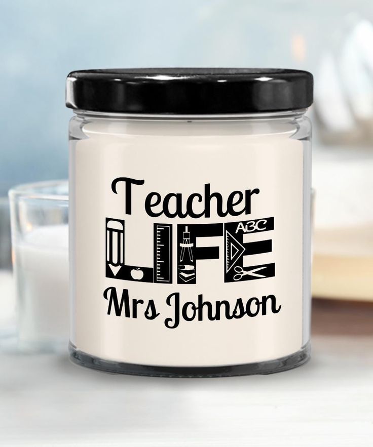 a glass jar with the words teacher life on it next to a cup of milk