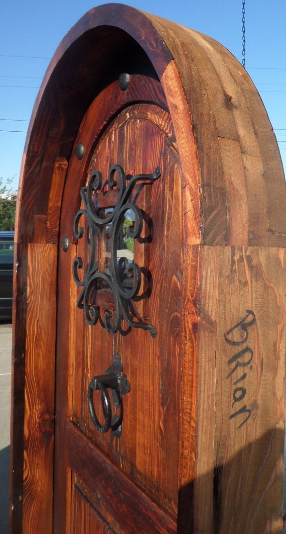 an old wooden door with iron work on it