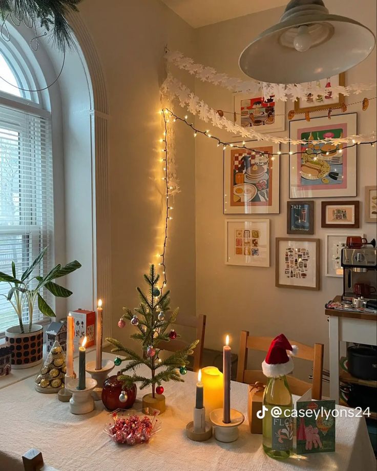 a dining room table decorated for christmas with lit candles