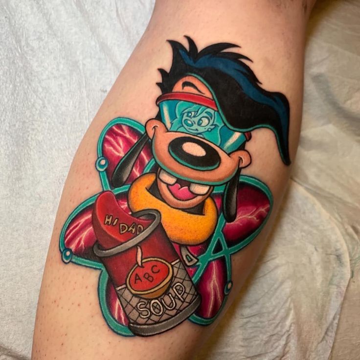 a cartoon character tattoo on the leg of a person wearing glasses and holding a bottle