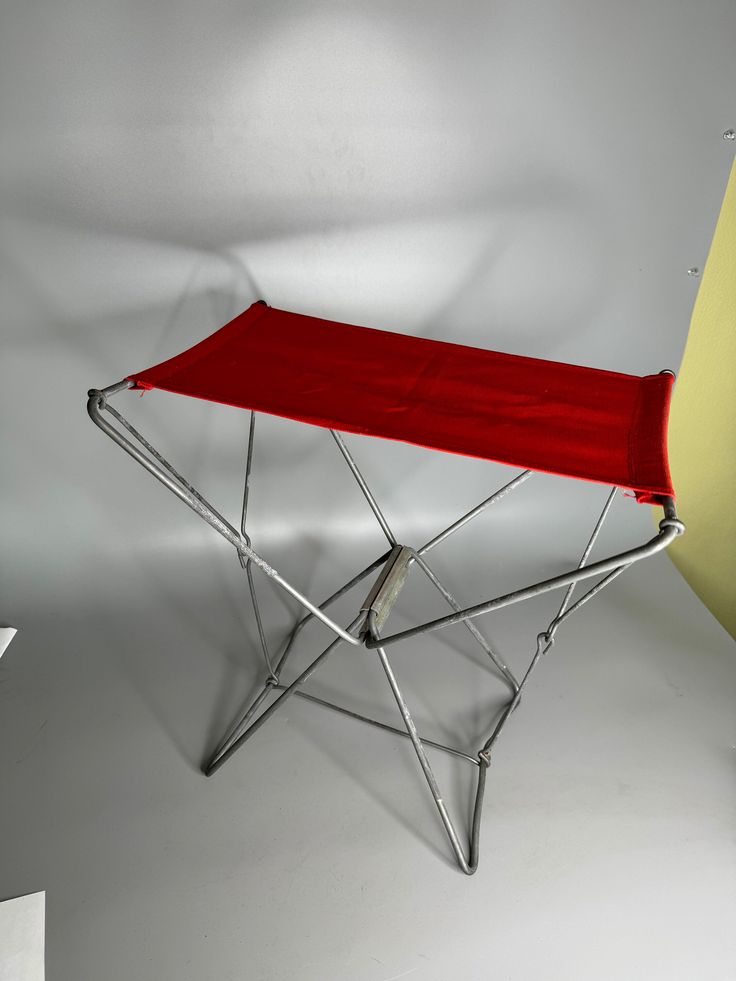 a red chair sitting on top of a white floor