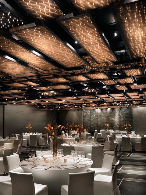 an empty banquet room with white tables and chairs