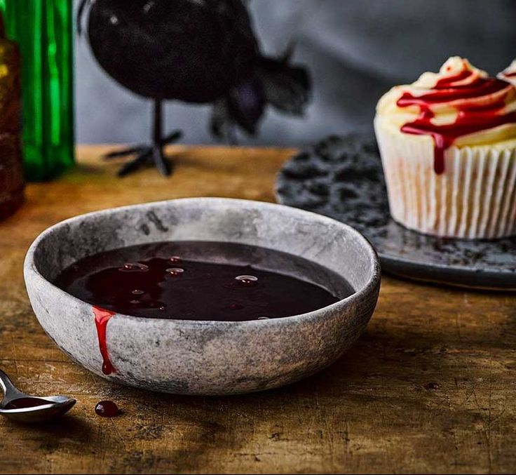 a cupcake sitting on top of a wooden table