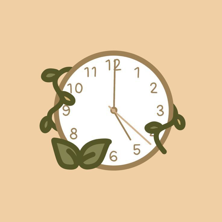 a clock with green leaves on the face