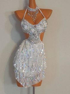 a mannequin wearing a white dress with silver sequins