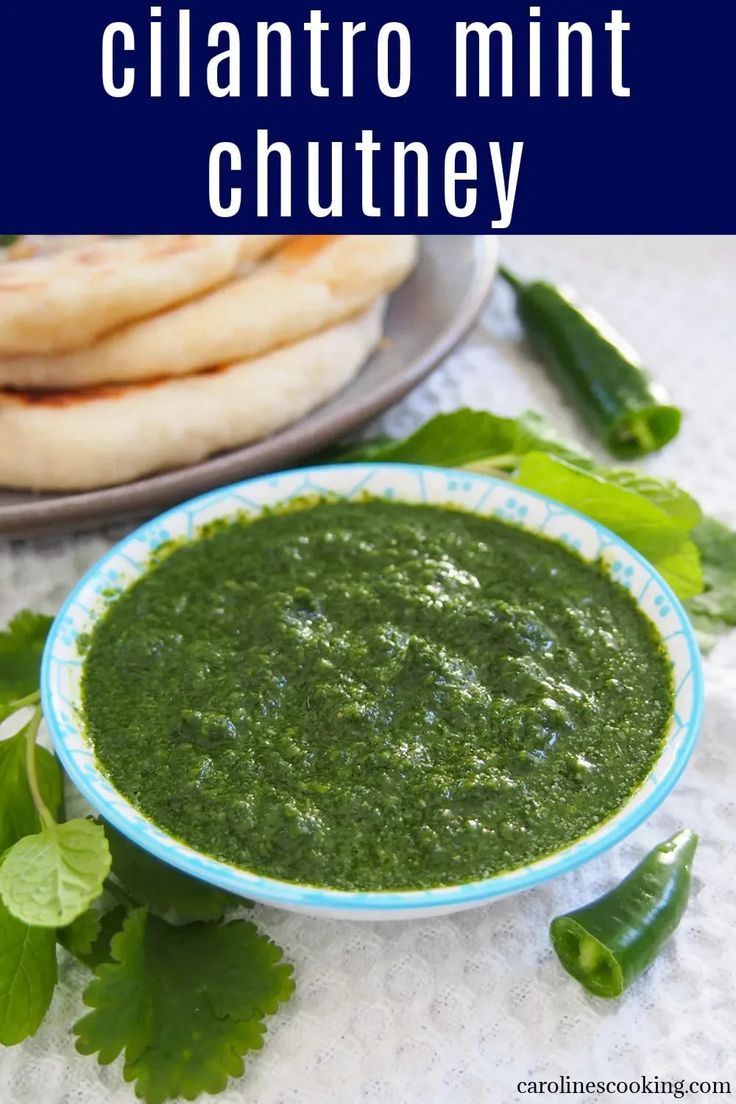 a bowl of cilantro mint chutney next to pita bread on a plate