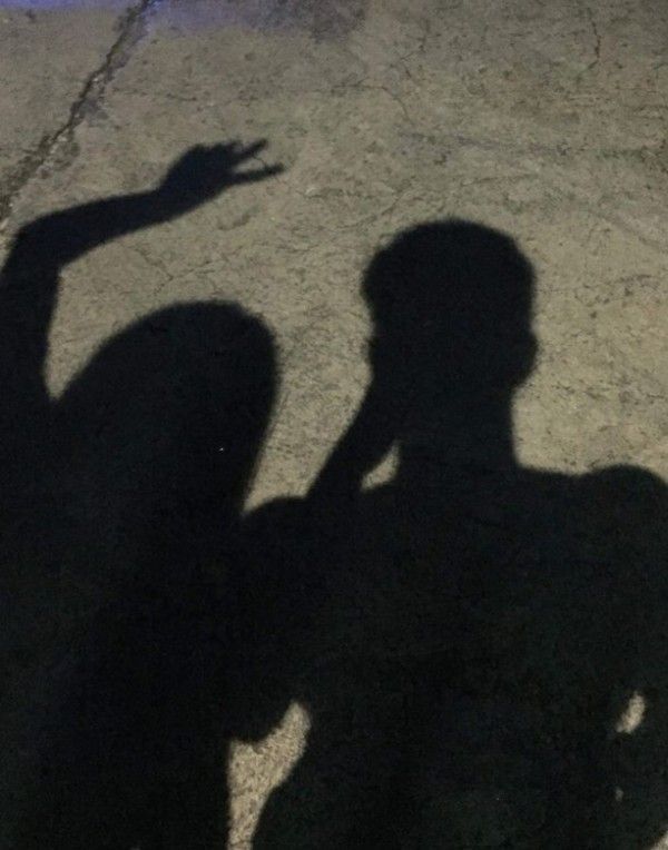 the shadow of a person holding a skateboard