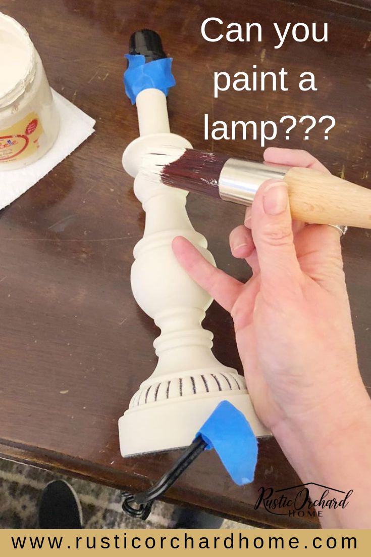 someone is painting a lamp with blue paint on the top and bottom of it, which says can you paint a lamp?