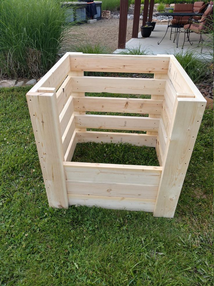 a wooden box sitting in the grass