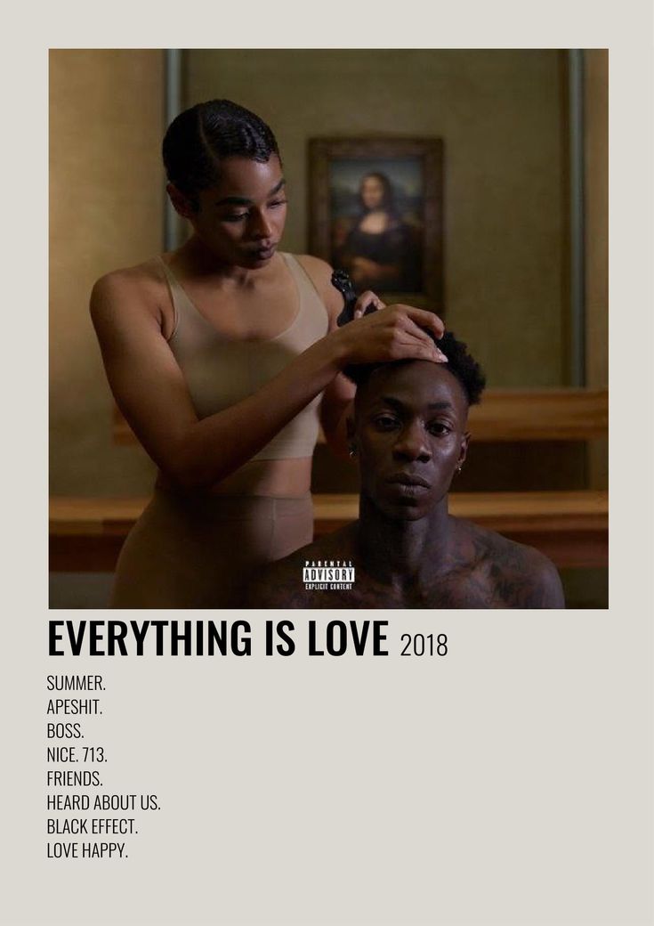 a man getting his hair cut by a woman in front of a painting with the words everything is love on it