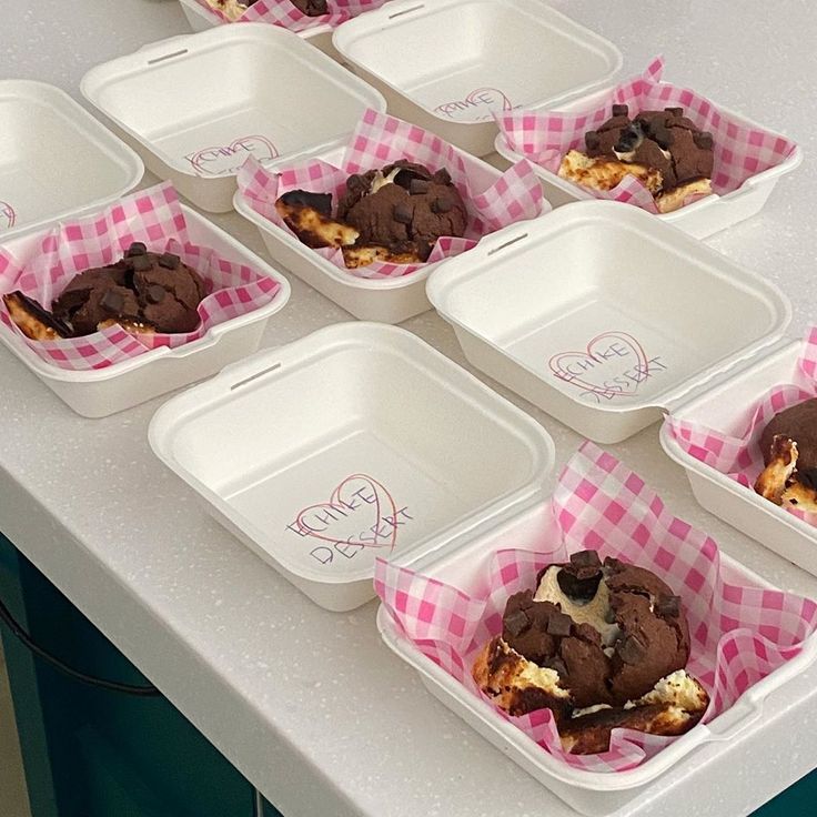 six plastic containers filled with ice cream and chocolate covered desserts on top of a counter