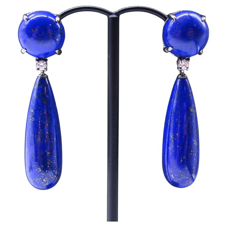 Lapis Lazuli Diamonds earrings in 18-carat black gold. This pair of earrings consists of a cabochon-shaped lapis lazuli mounted on an articulated 18-carat black gold hanger. A brilliant-cut diamond separates it from the second, candelabra-shaped lapis lazuli part. Length: 1.5 inch Depth: 0.19 inch Width: 0,5 inch Total weight of the pair: 15.4 grams. Weight of 18-carat gold: 3.12 grams These earrings are easy to fasten thanks to the pram clasps, which make them simple and secure to use. The clasp is made of 18-carat gold. This pair of earrings can be worn for all occasions, and will dress up an evening outfit as well as an everyday outfit. This bright blue will go perfectly with all accessories and outfits. In perfect condition. Gold Hangers, Earrings Diamonds, Diamonds Earrings, Evening Outfit, Evening Outfits, Diamond Gold, Brilliant Cut Diamond, Bright Blue, Lapis Lazuli