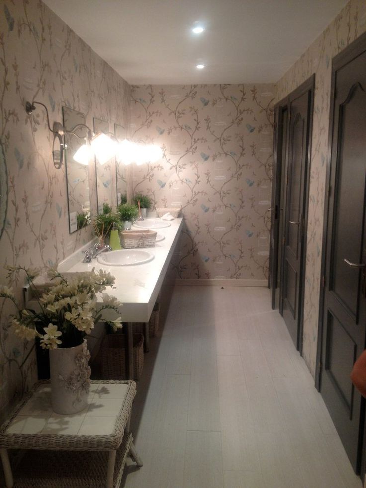 a bathroom with two sinks and mirrors on the wall next to each other in front of a door