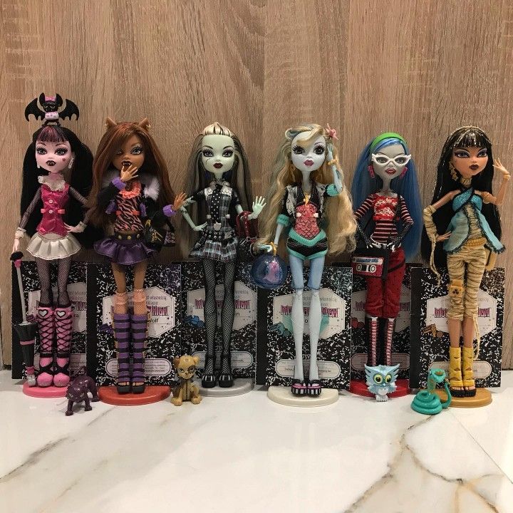 the monster dolls are lined up in a row on top of each other, all wearing different outfits