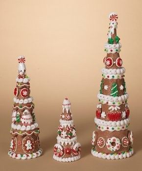 three christmas trees made out of gingerbread and candy canes on a brown background