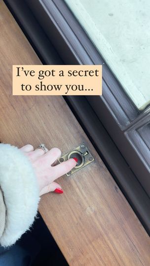 a woman's hand holding a pair of scissors in front of a sign that says i've got a secret to show you