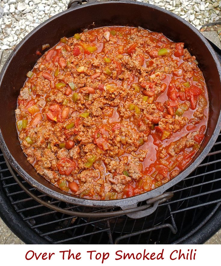 a large skillet filled with food on top of a grill