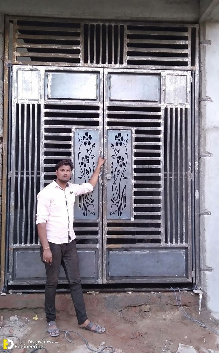 a man standing in front of a metal door