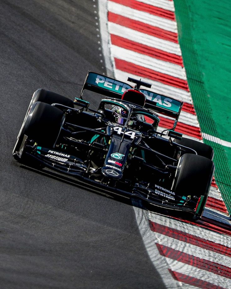 a man driving a racing car down a race track