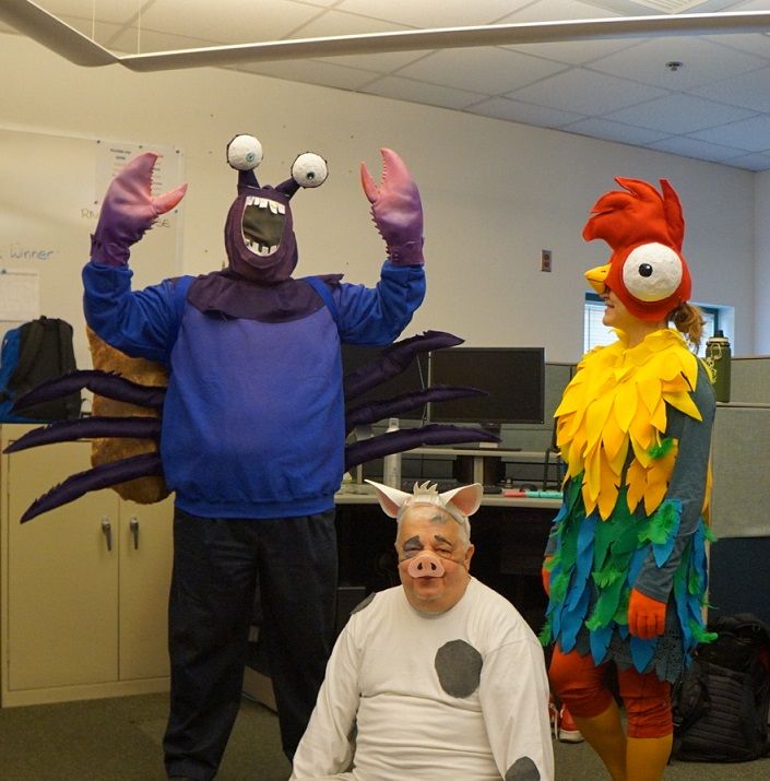 two men in costumes standing next to each other with one man wearing a costume on his head