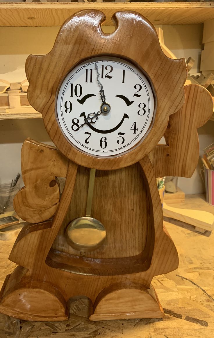 a wooden clock sitting on top of a table