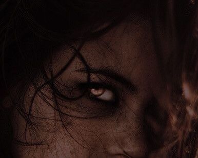 a woman's face with long hair and blue eyes is shown in this artistic photograph