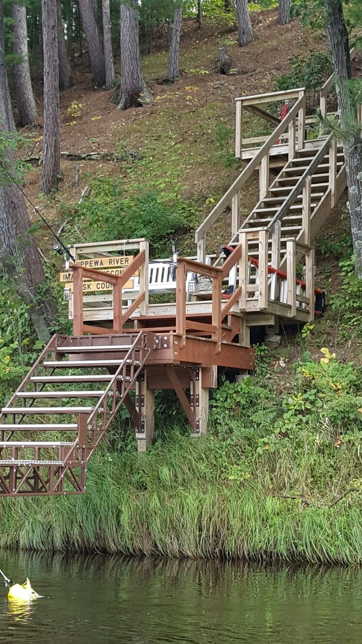 there is a small boat on the water near a dock and stairs that lead up to it