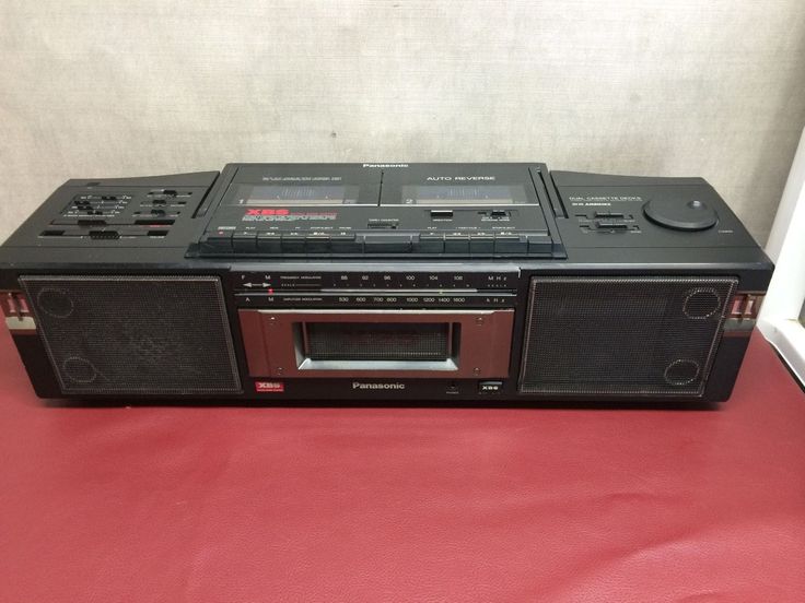 an old radio sitting on top of a red table