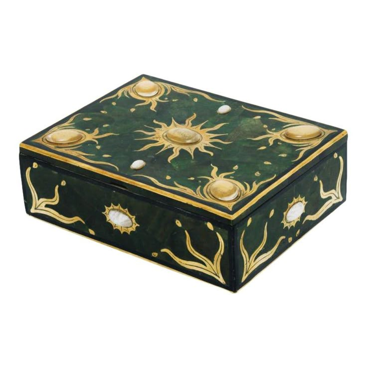 a green and gold box sitting on top of a white surface with sun decorations around it