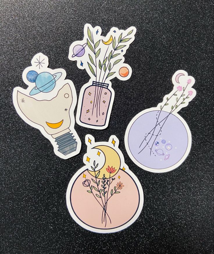 four stickers with flowers and plants in vases on a black surface, one is pink