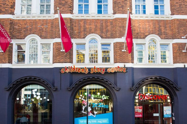 the children's story court store front is blue and has red flags on it