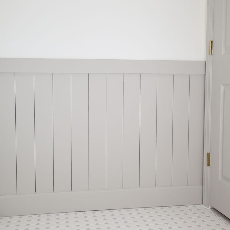 a bathroom with white walls and tile flooring