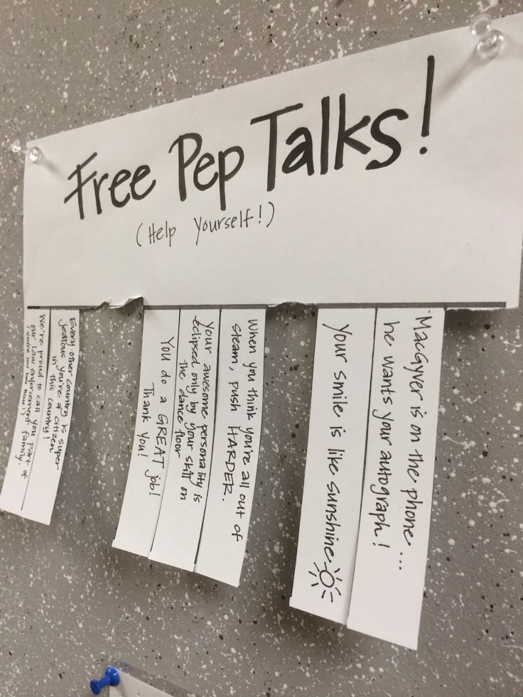 several pieces of paper taped to the side of a wall with free pep talks written on them