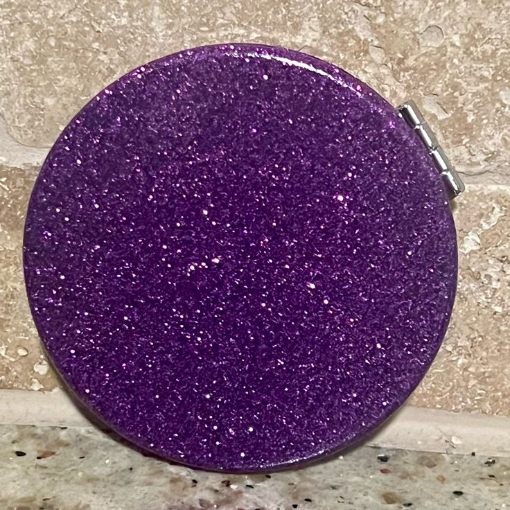 a purple button sitting on top of a counter