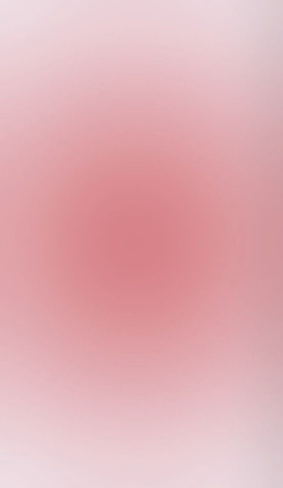 a red and white blurry background with an oval shape