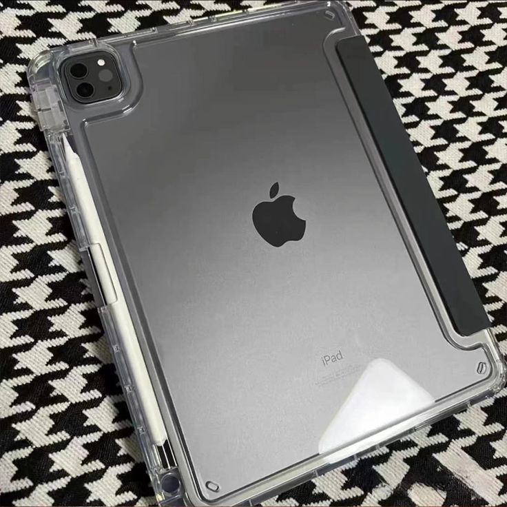 an ipad case sitting on top of a black and white blanket