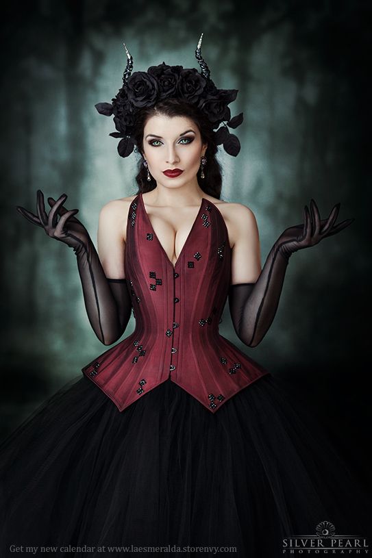 a woman in a red corset with black gloves on her head and hands out