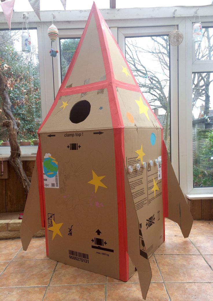 a cardboard rocket ship made to look like a house