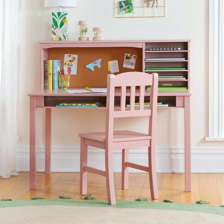 a pink desk and chair in a room