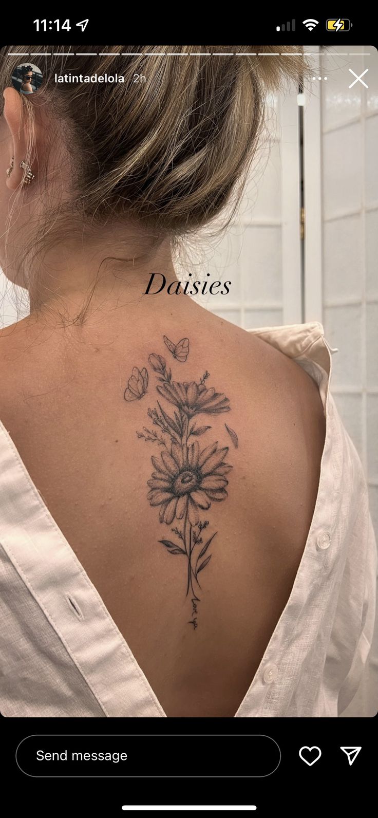 the back of a woman's neck with flowers tattooed on her upper and lower back