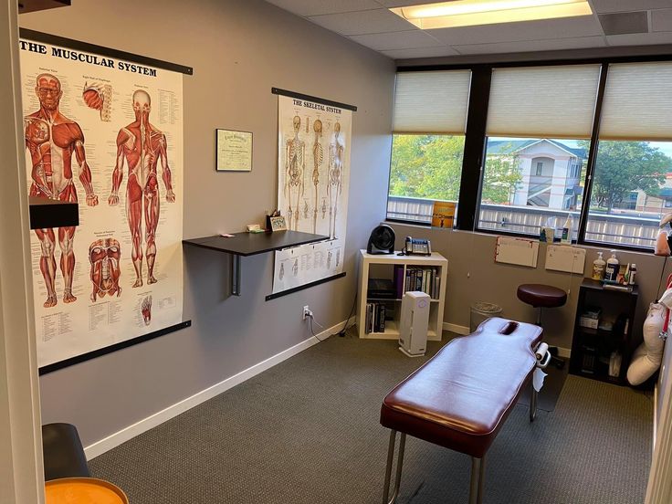 an office with posters on the wall and desks