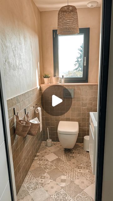 a bathroom with tiled walls and flooring in the middle of it is seen through an open door