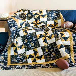 a bed with a quilt and pillows on it