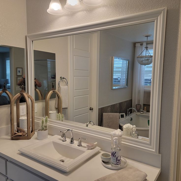 a bathroom sink sitting under a large mirror