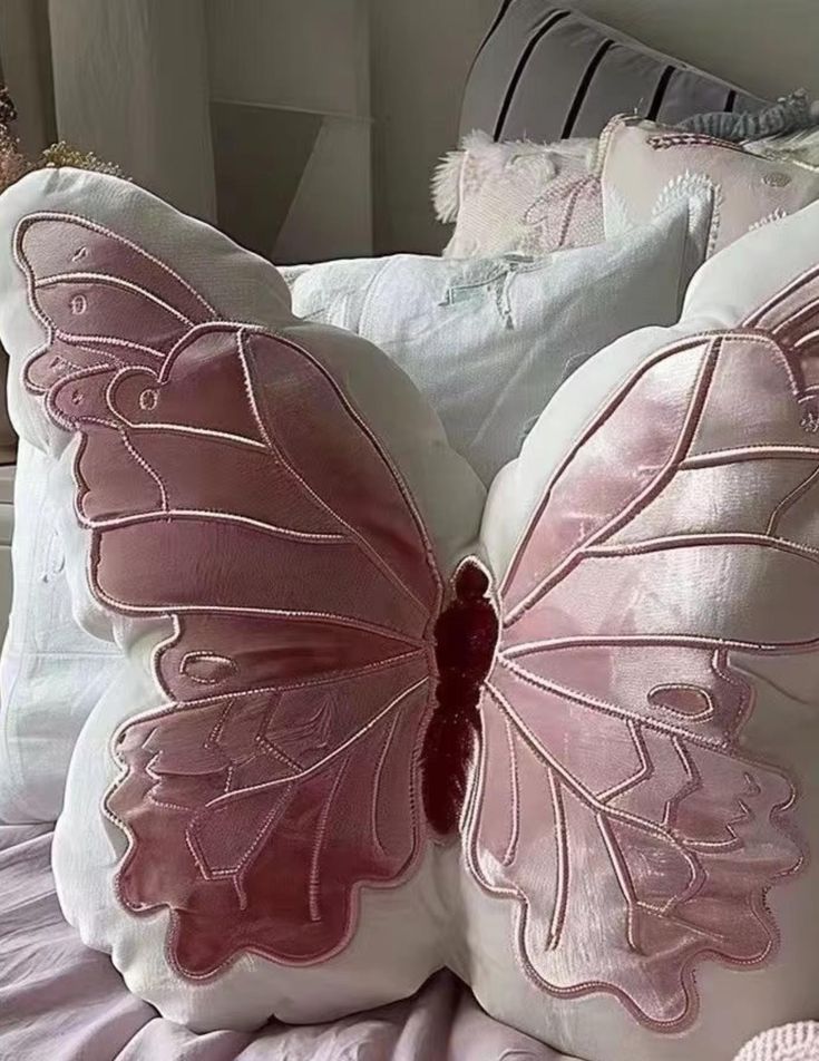 two pillows with pink and white designs on them