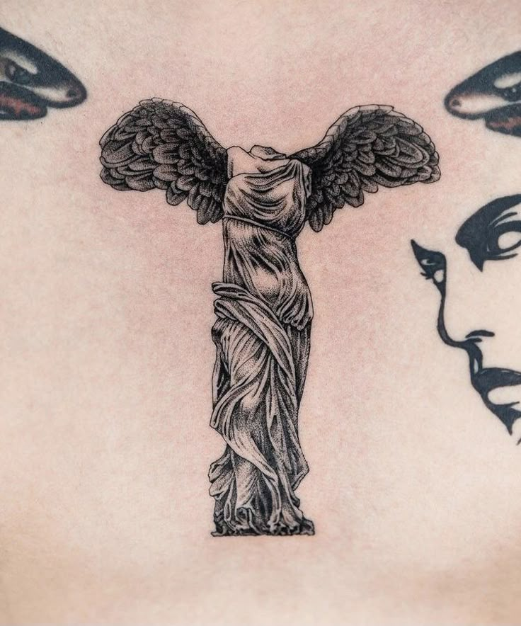 a woman's chest with an angel statue on it and two faces behind her