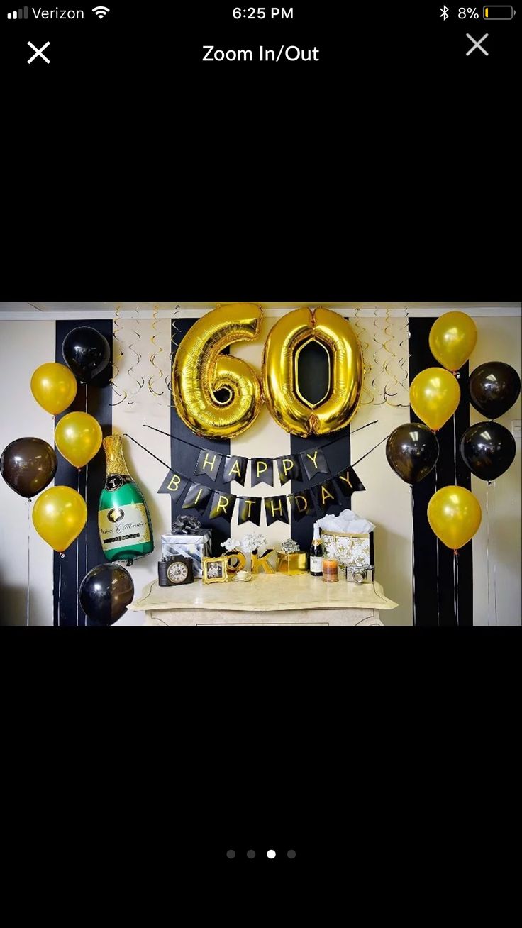 a table topped with balloons and confetti next to a sign that says 60