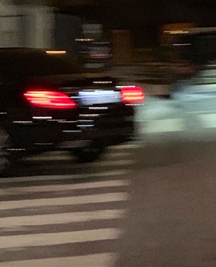 a blurry photo of cars driving down the street